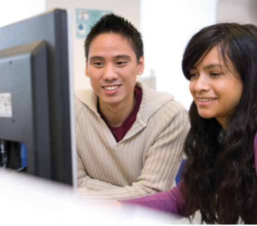 A male and a female preparing for ielts on computer