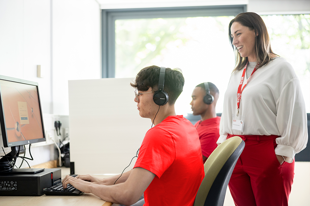 Students in class with teacher behind