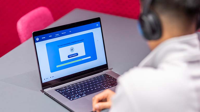 A man with headphones taking the IELTS listening section A man taking the listening section of the IELTS