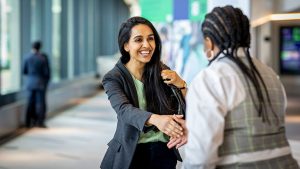 Two women introduce each other and have a conversation