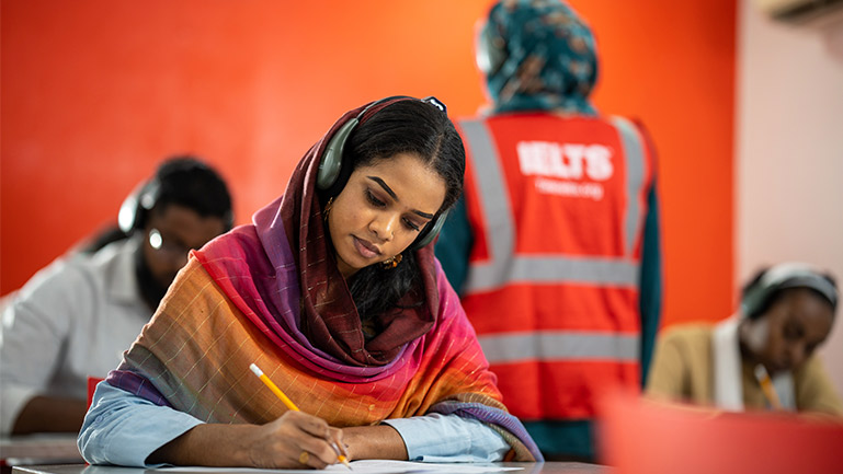 A woman is taking the IELTS exam.