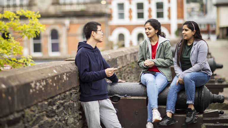 A group of international students talking. A group of international students at a university